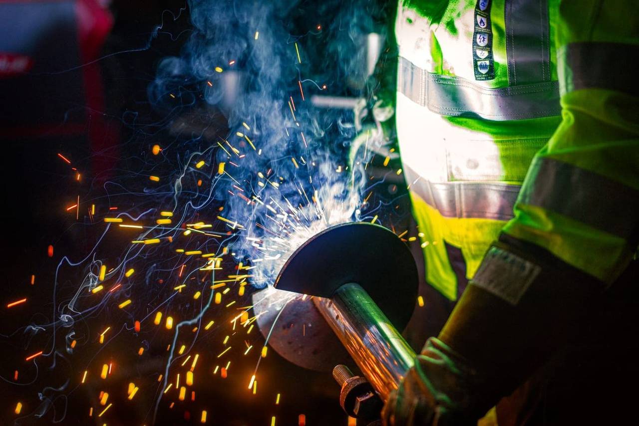 Paalupiste manufacturing — sparks from grinding work on a helical pile