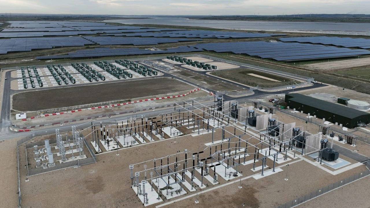 Aerial view of Cleve Hill BESS battery container array next to the on-site electrical compound, Kent UK
