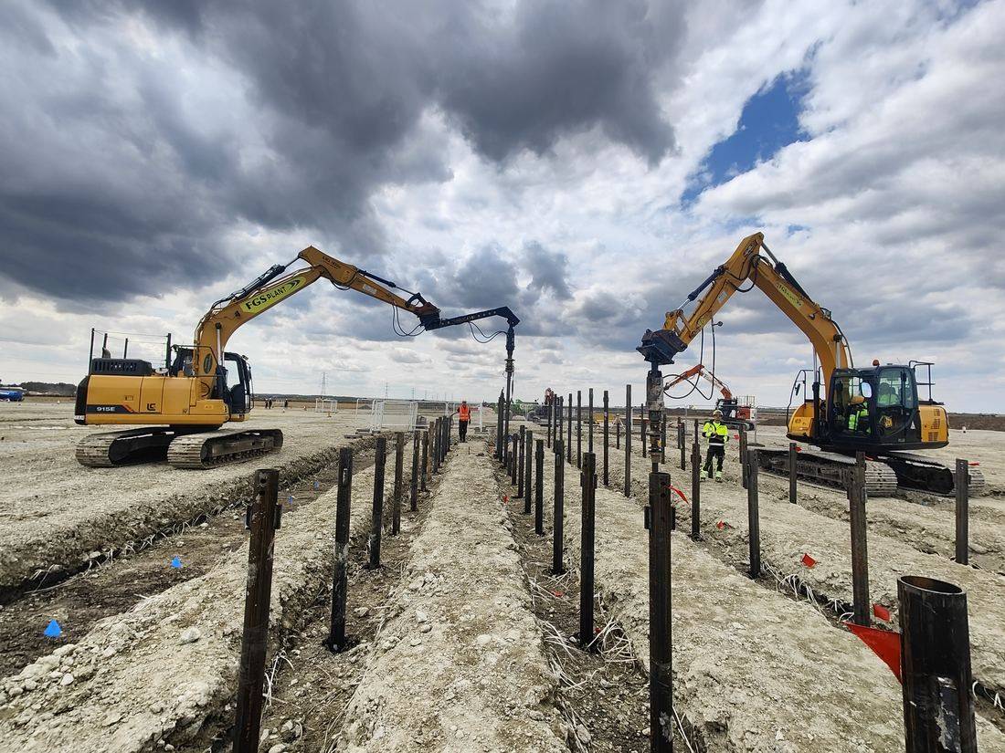 Two Helicasol excavators driving piles in parallel for an electrical compound foundation